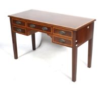 An Edwardian crossbanded mahogany writing desk. Stamped PH.R & Co Holt.