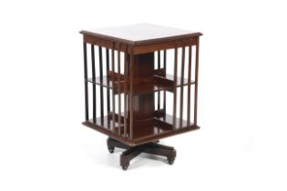 An Edwardian Sheraton Revival mahogany and string inlaid rotating bookcase on casters. H68.