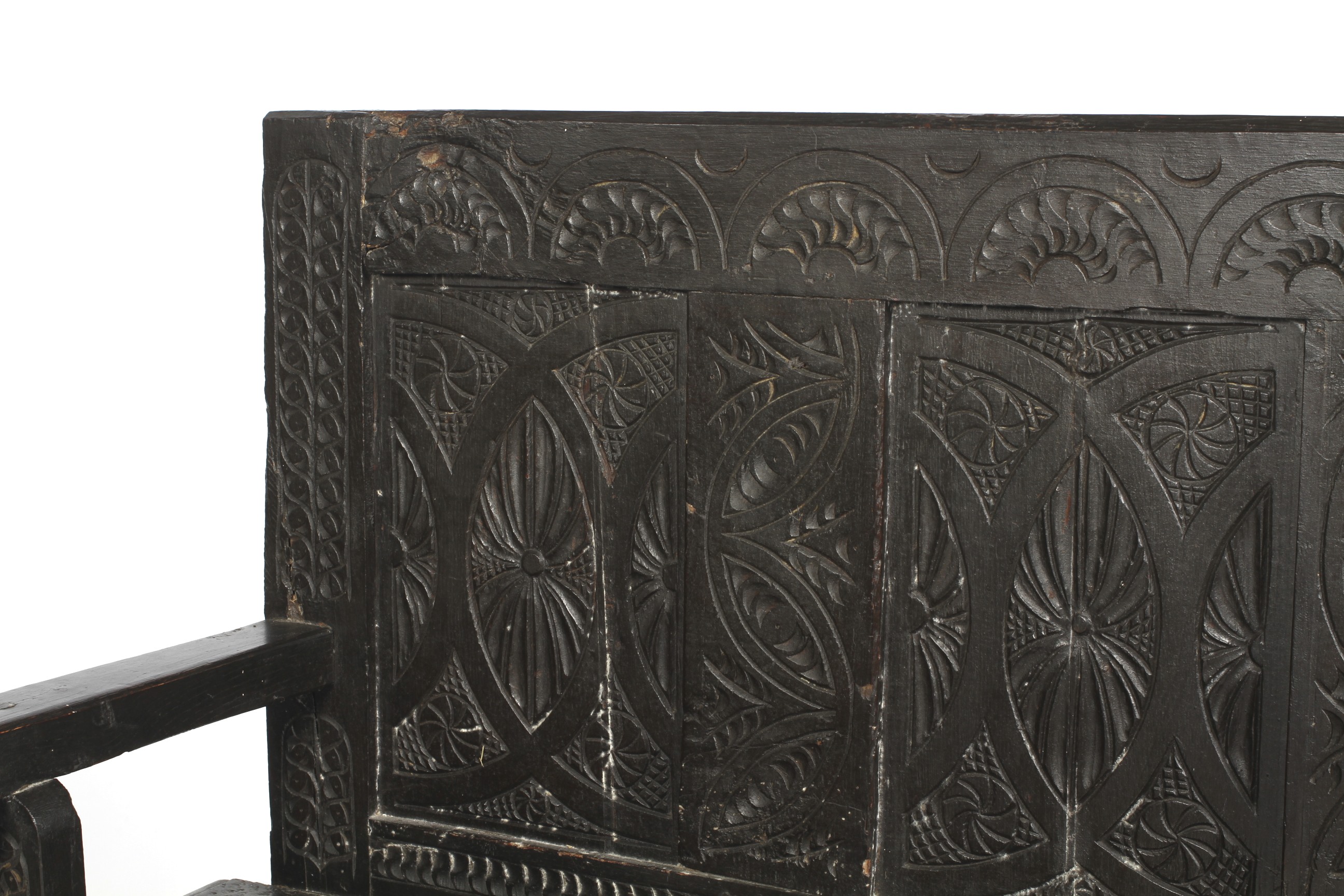 A Victorian carved and ebonised pine panel back settle or bench with open arms. H105. - Image 2 of 2