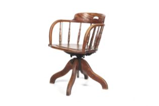 An early 20th century swivel desk/captains chair with spindle gallery back. Circa H77cm.