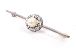 A late Victorian gold, pearl and diamond cluster knife-edge bar brooch. Centred with an untested 5.