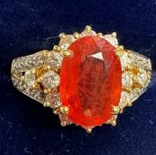 A Gems TV 18ct gold, orange sapphire and near colourless stone oval cluster ring.