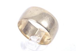 A vintage 9ct gold broad wedding band. Of shallow D-section, hallmarks for London 1973, 10.