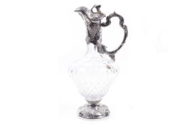 A vintage silver mounted clear cut glass claret jug.