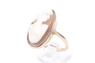 An early 20th century gold and oval shell cameo ring.