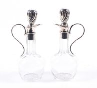 A pair of clear-glass long-neck baluster-shaped oil and vinegar bottles.