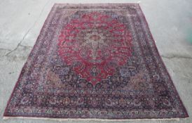 A large Persian hand woven wool rug/carpet.