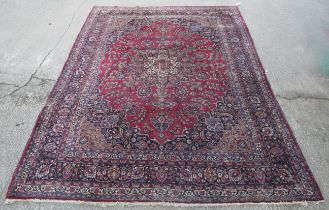 A large Persian hand woven wool rug/carpet.