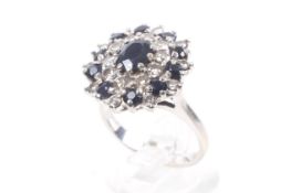 A vintage sapphire and diamond 'target' cluster ring, stamped '18ct'.
