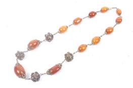 A North African amber and gilt bead necklace.