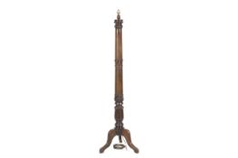 A William IV mahogany standard lamp on a tripod base with lotus flower decoration. H149.5cm.