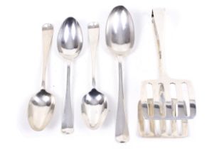 A silver serving tongs and four spoons.
