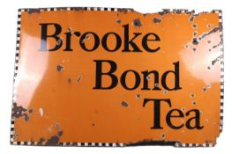An advertising vitreous enamel sign for 'Brooke Bond Tea'.