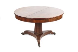 A Victorian mahogany round extending dining table.