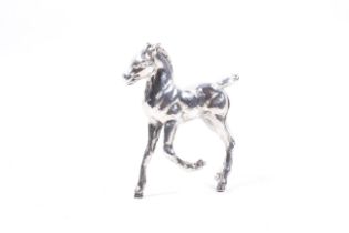 A vintage silver model of a prancing pony. Hallmarks for London 1974, 9cm high overall, approx.