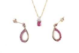 A pair of ruby and diamond open drop earrings stamped '9ct' and a necklace stamped '585'.