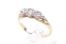 An early 20th century platinum-flashed gold and diamond three stone ring.