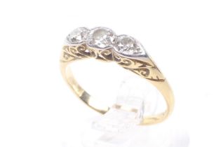 An early 20th century platinum-flashed gold and diamond three stone ring.