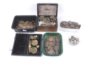 A large quantity of pennies and world coins. Including a boxed set of scales with some weights.