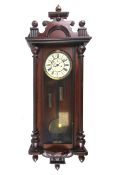 A circa 1900 two-weight walnut Vienna Regulator striking wall clock.