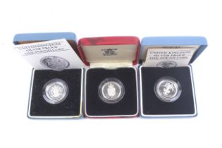 Three silver proof £1 coins for 1983, 1985 and 1988.