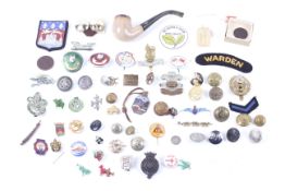 An extensive collection of assorted military cap badges and buttons.
