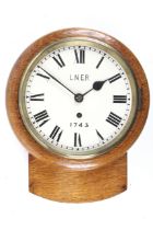 A LNER, railway waiting room wall clock. With an oak case. An 8 day chain fusee movement.