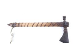 A tomohawk style axe with integrated pipe. With iron studs and burnt ring pattern to handle. L45.
