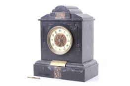 A Victorian black slate mantel clock. Carved and inlaid decoration to the case.
