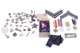 An assortment of WWII and later British and US military medals, patches, etc.