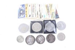 A small group of coins and cigarette cards. Including a 1889 crown and two 1889 double florins.