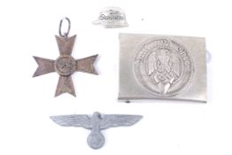 Four German military badges and buckles.