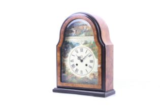 A contemporary 8 day mantel clock with rural scene dial.