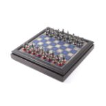 A Battle of Waterloo Franklin Mint 1984 chess set with a matching chess table.