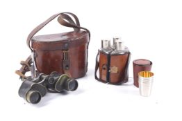 A set of WWI military cased binoculars, a triple hip flask set and metal shot glass set.