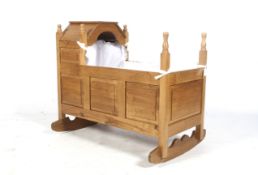 A handmade blonde oak babies rocking craddle crib. With removeable hood and panelled sides.