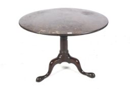 A Georgian oak circular tilt top table.