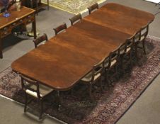 A large ten-twelve seat Regency style mahogany extending twin pedestal dining table.