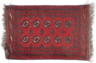 A small Afghan Royal Bokharas gul design red wool rug.