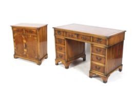 A 20th century Regency revival style yew wood veneer twin pedestal desk and cabinet.