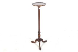 A 20th century mahogany tripod torchiere stand.