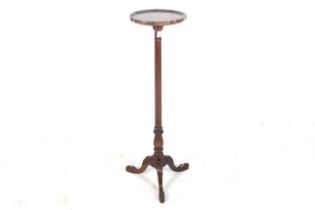 A 20th century mahogany tripod torchiere stand.