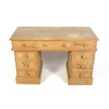 A contemporary twin pedestal pine desk.