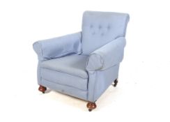 An Edwardian re-upholstered blue fabric button back armchair.