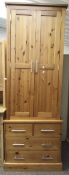 A contemporary pine wardrobe on chest.