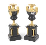 A pair of Regency style garnitures of slate, bronze and ormolo.