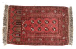 A small red ground prayer rug.