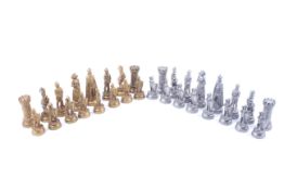 A 20th century collector's pewter chess set. 'Medieval' design, gold and silver coloured.