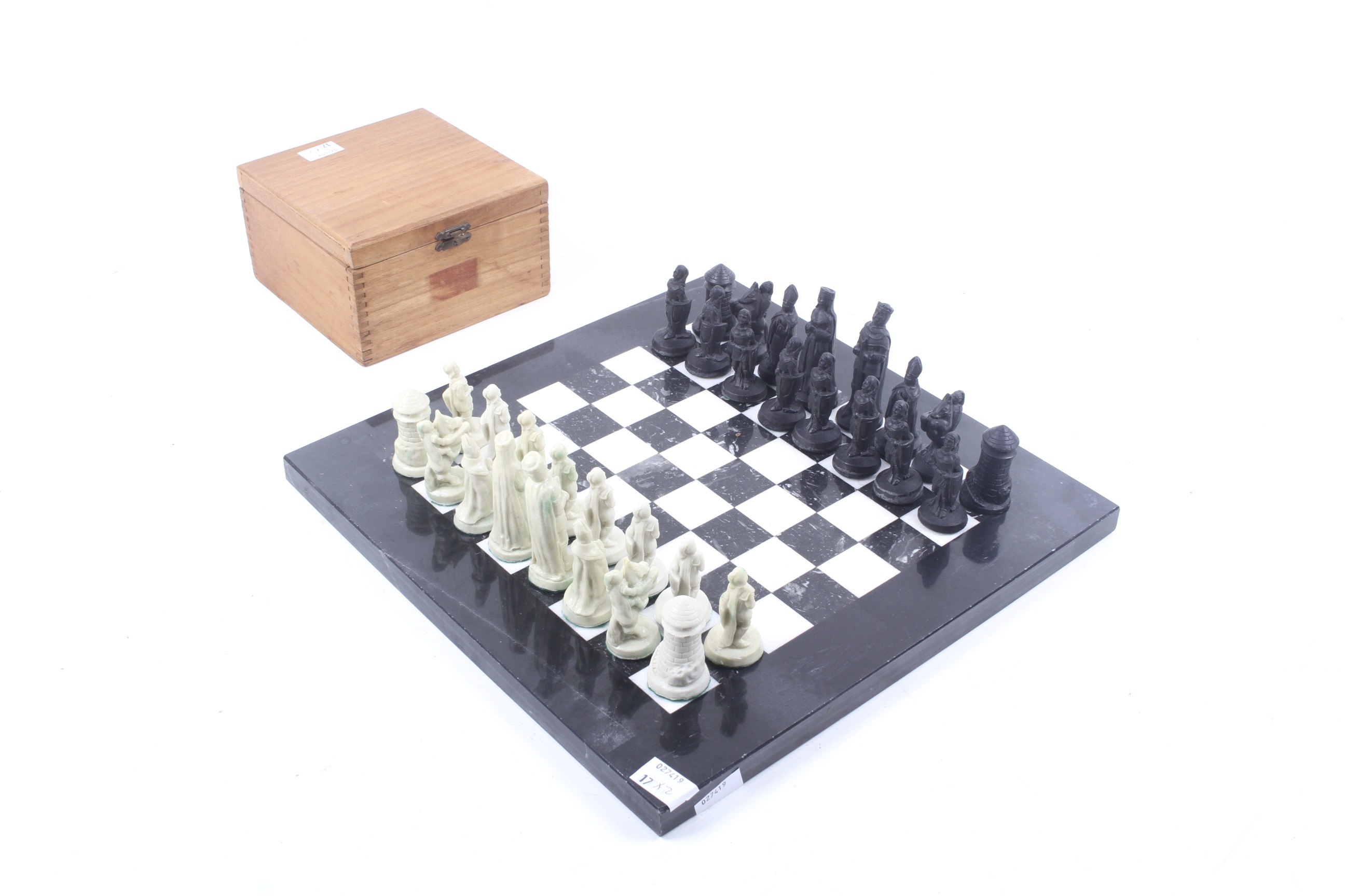 A resin chess set and marble chequerboard.