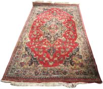 A Persian Feraghan style red and blue wool rug.